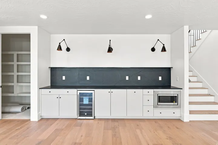 Built-in cabinetry with a dark countertop, integrated beverage refrigerator, and built-in microwave