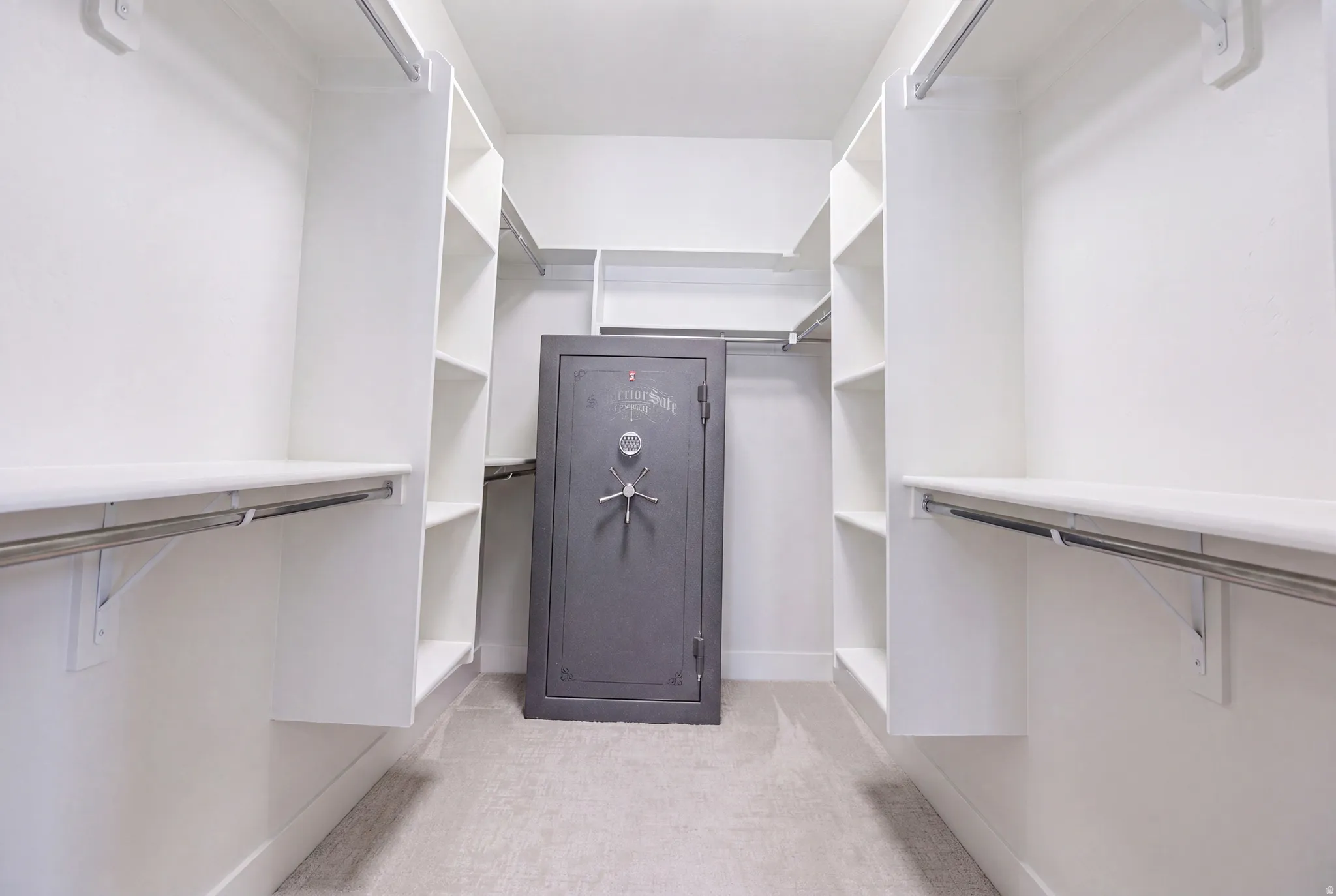 Custom closet system featuring extensive shelving and hanging rods