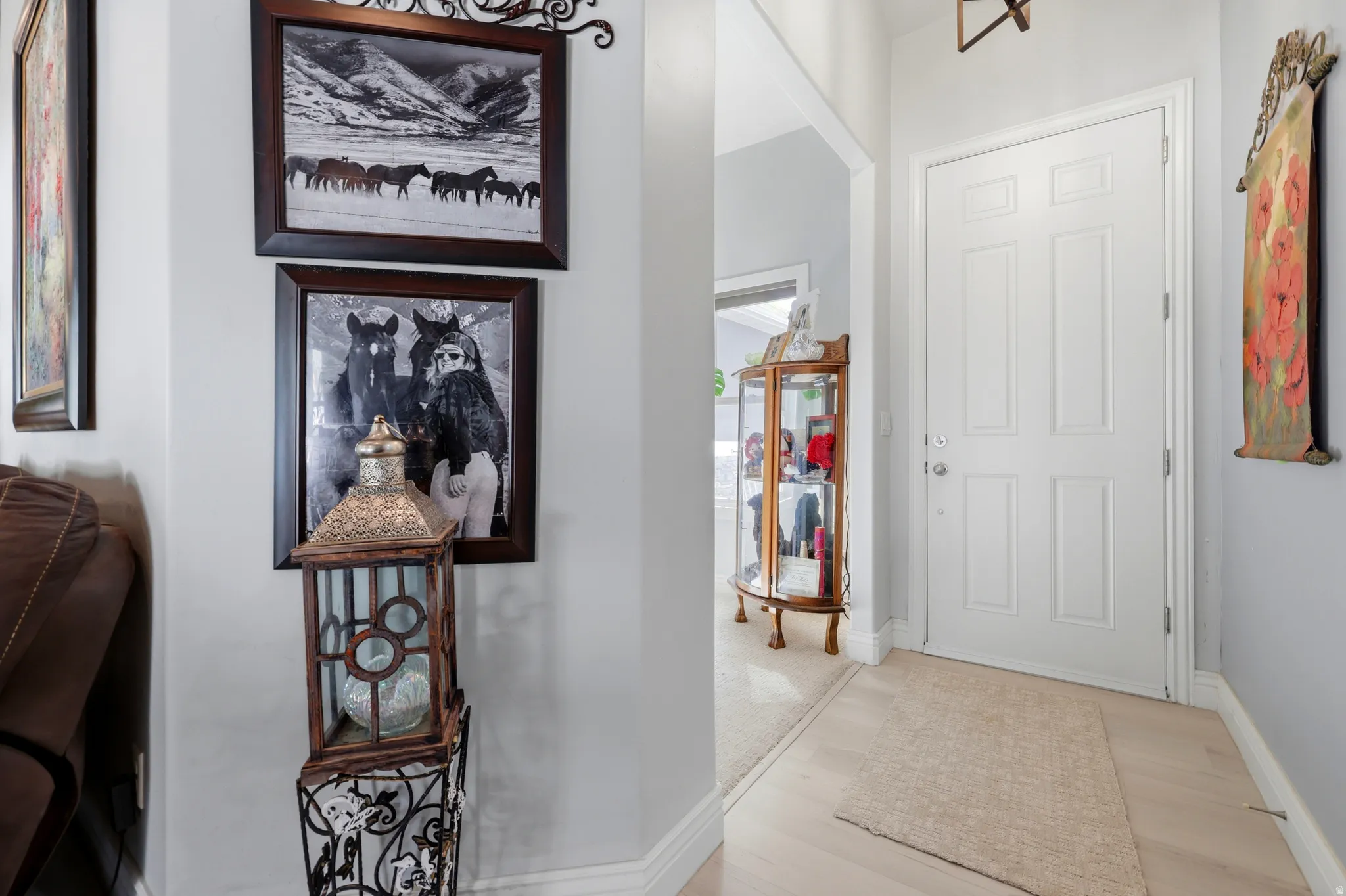 Entryway featuring a paneled door, light-toned flooring, and neutral wall paint