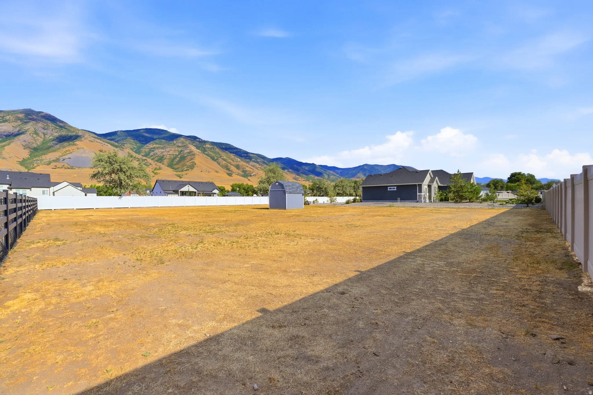 Expansive land parcel with surrounding mountain backdrop