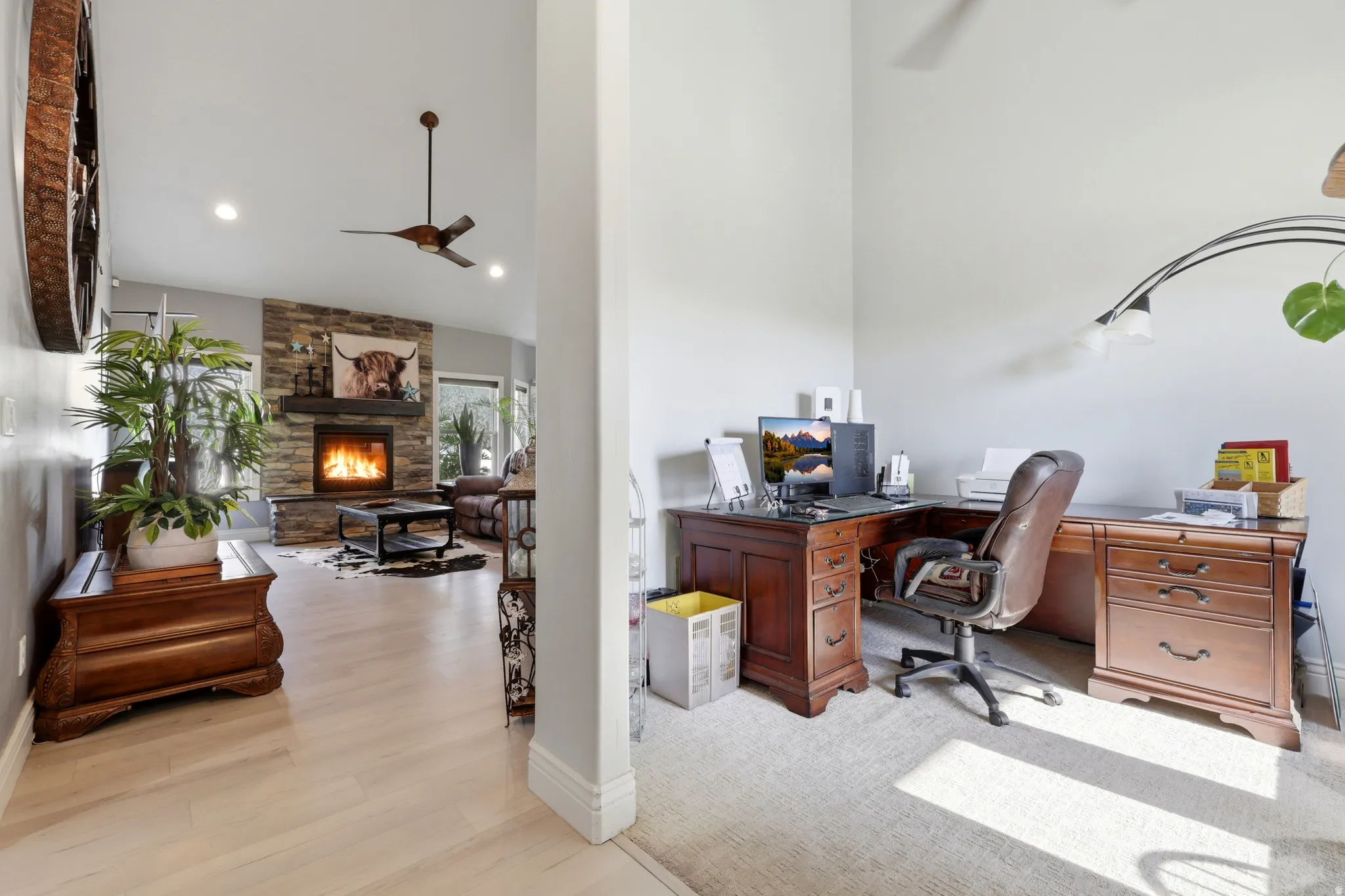 Living area featuring a stone-clad fireplace with a dark wood mantel, recessed lighting, and a ceiling fan