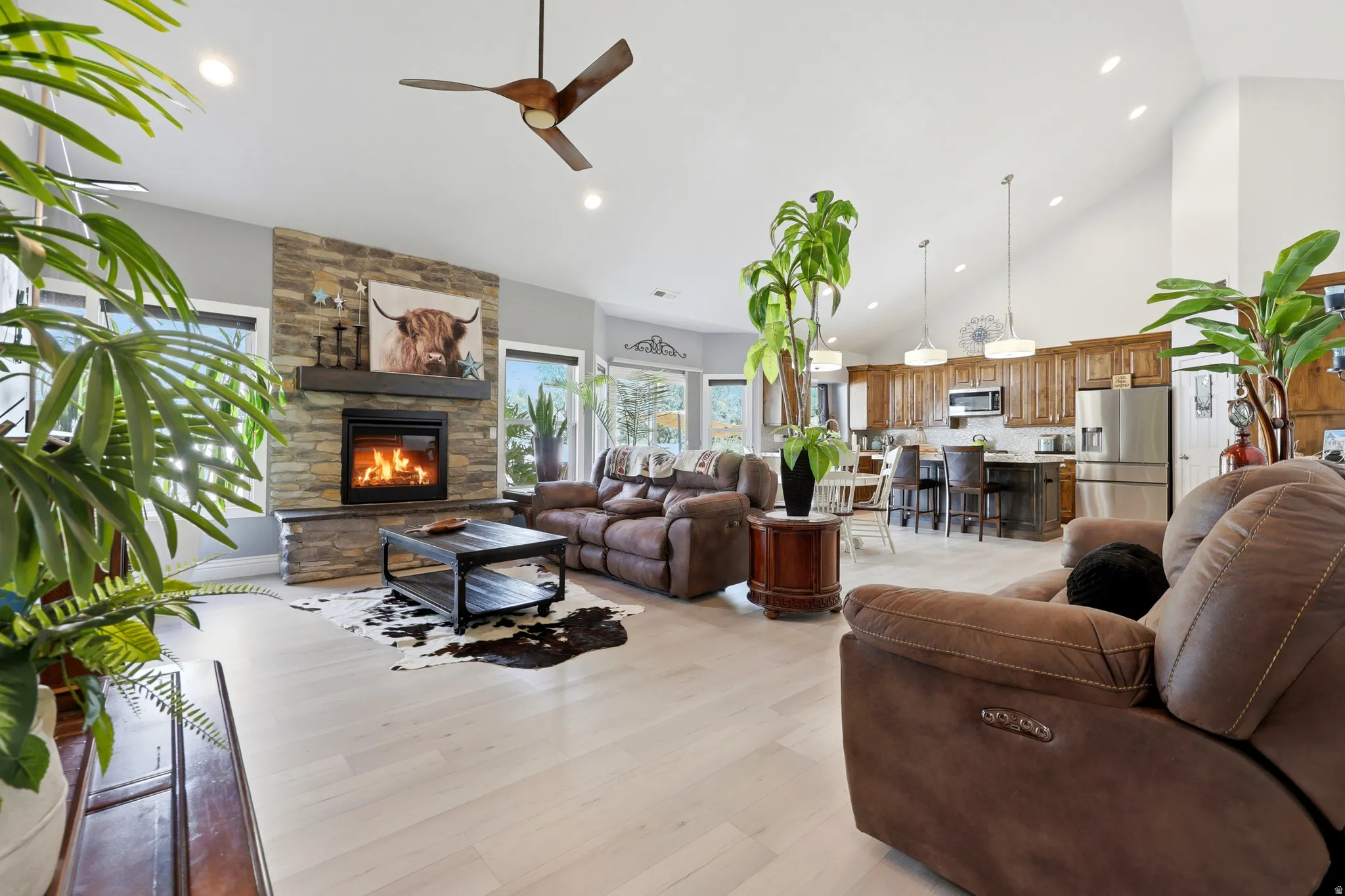 Vaulted ceilings above a stone fireplace with a wood mantle