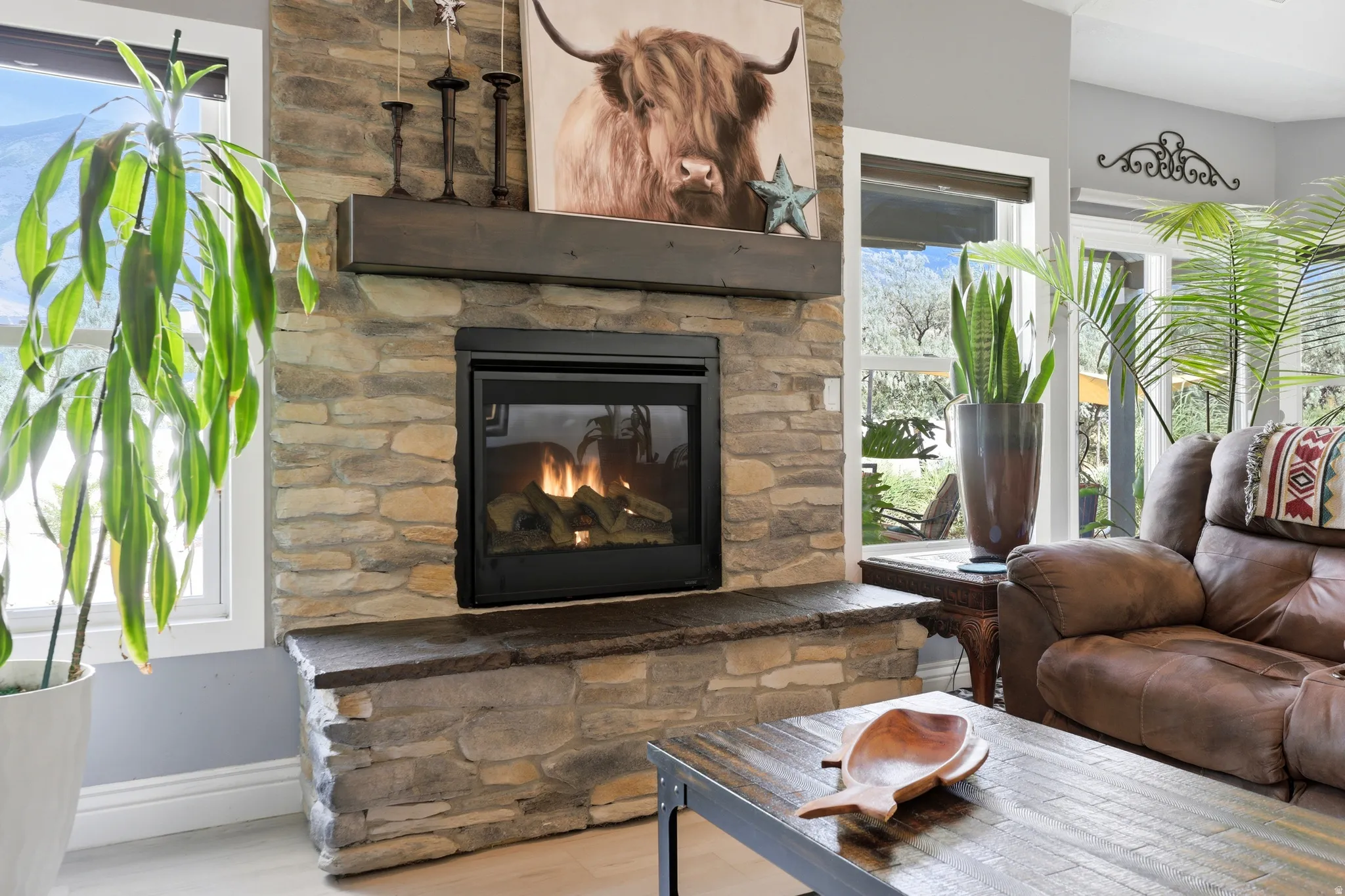 Stone-clad fireplace with a dark wood mantel and a built-in firebox