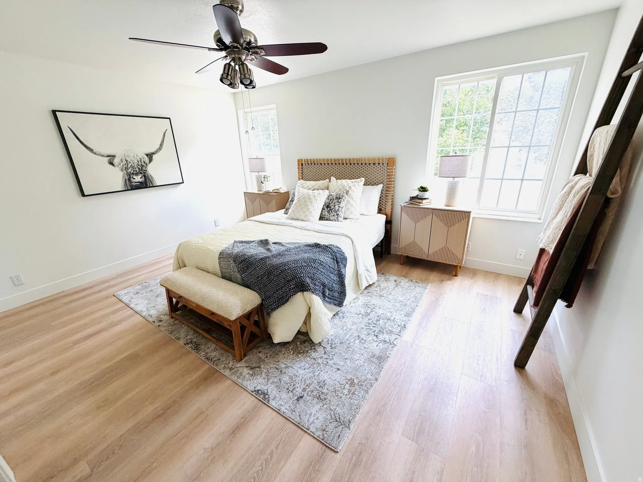 Bright room featuring light wood-finish flooring and white baseboards