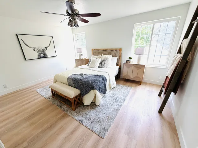 Bright room featuring light wood-finish flooring and white baseboards