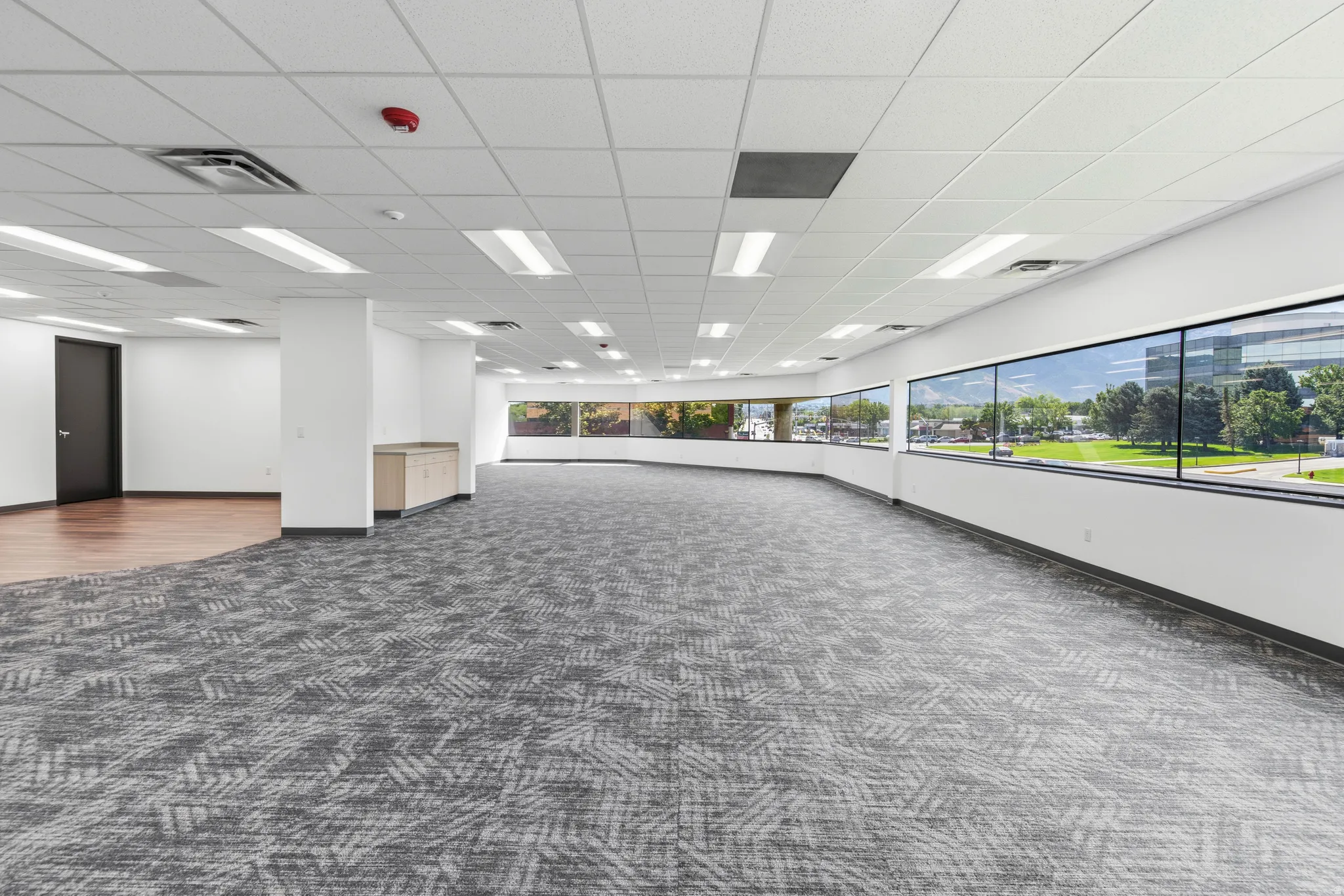 Expansive open-concept space featuring a curved wall of large windows