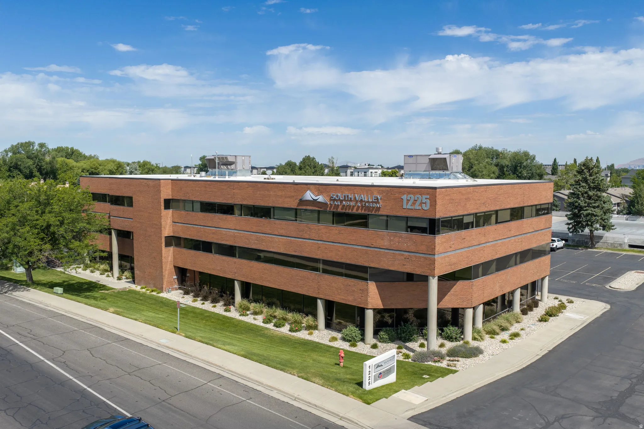 Three-story commercial building featuring brick exterior construction and extensive ribbon windows
