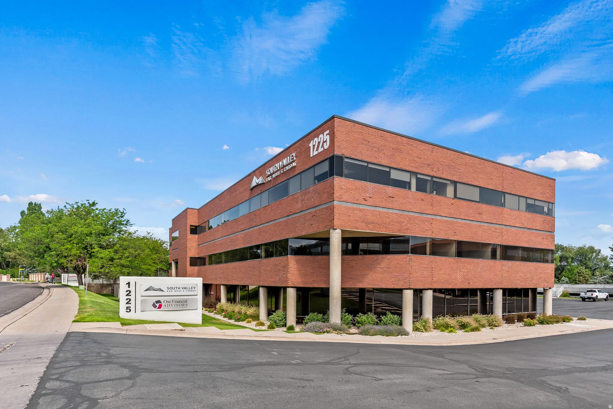 Brick exterior commercial building with multiple stories and expansive tinted windows