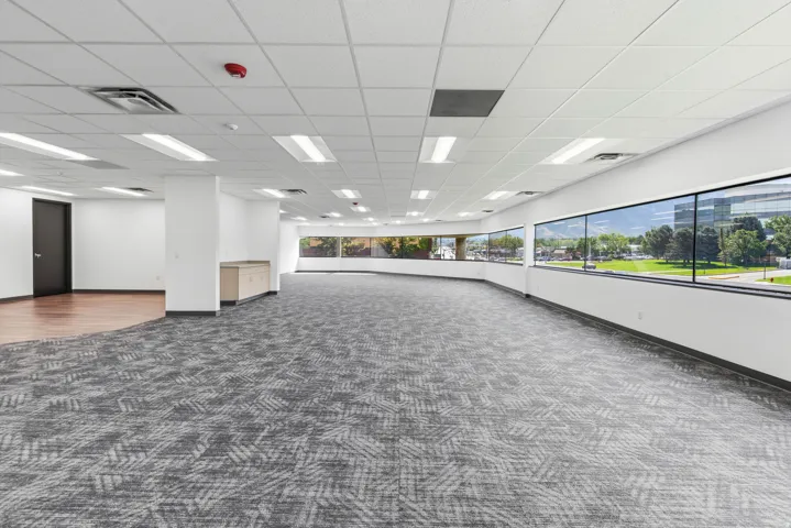 Expansive open-concept space featuring a curved wall of large windows