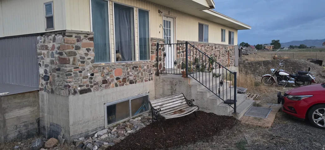 Exterior showcasing stone veneer accents and light-colored siding