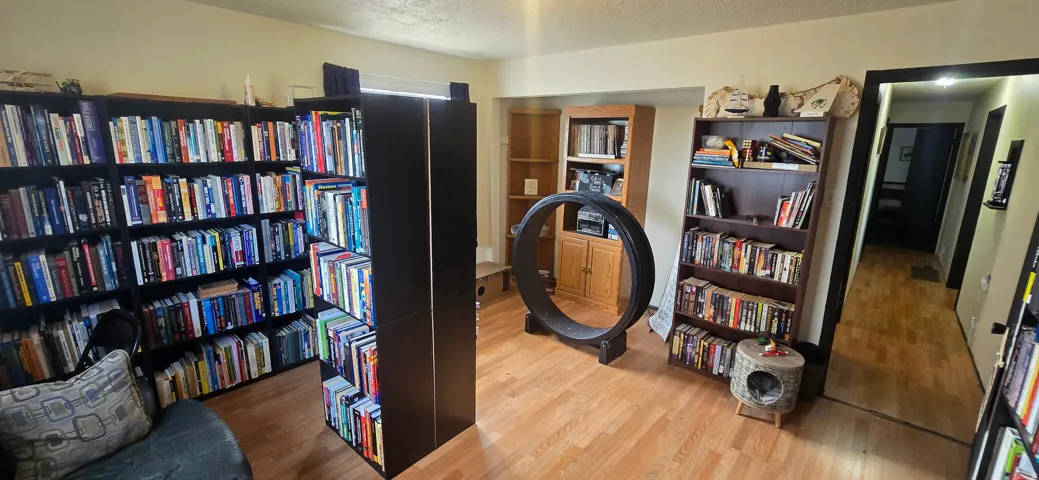 Light wood-finish flooring complements the neutral wall color