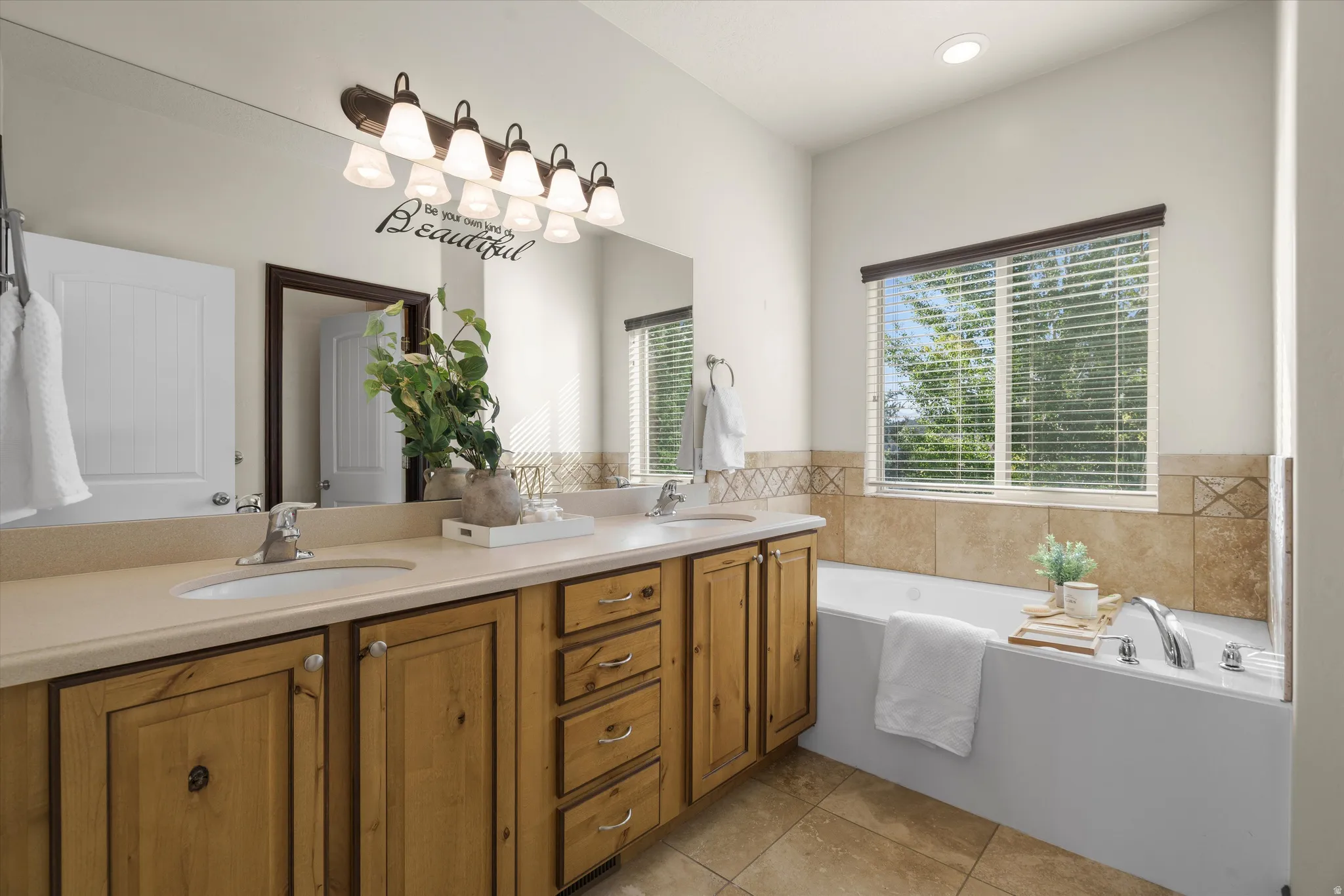 Master Bath with Dual vanity with integrated sinks and a light-toned countertop