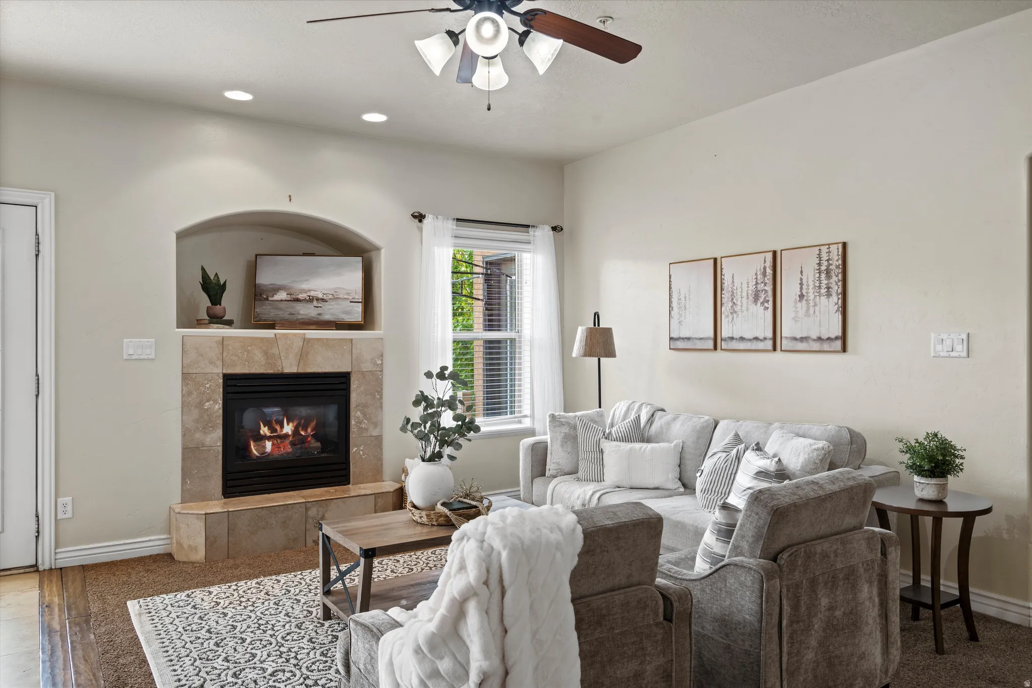 Living area featuring a tile-surround fireplace with an arched alcove