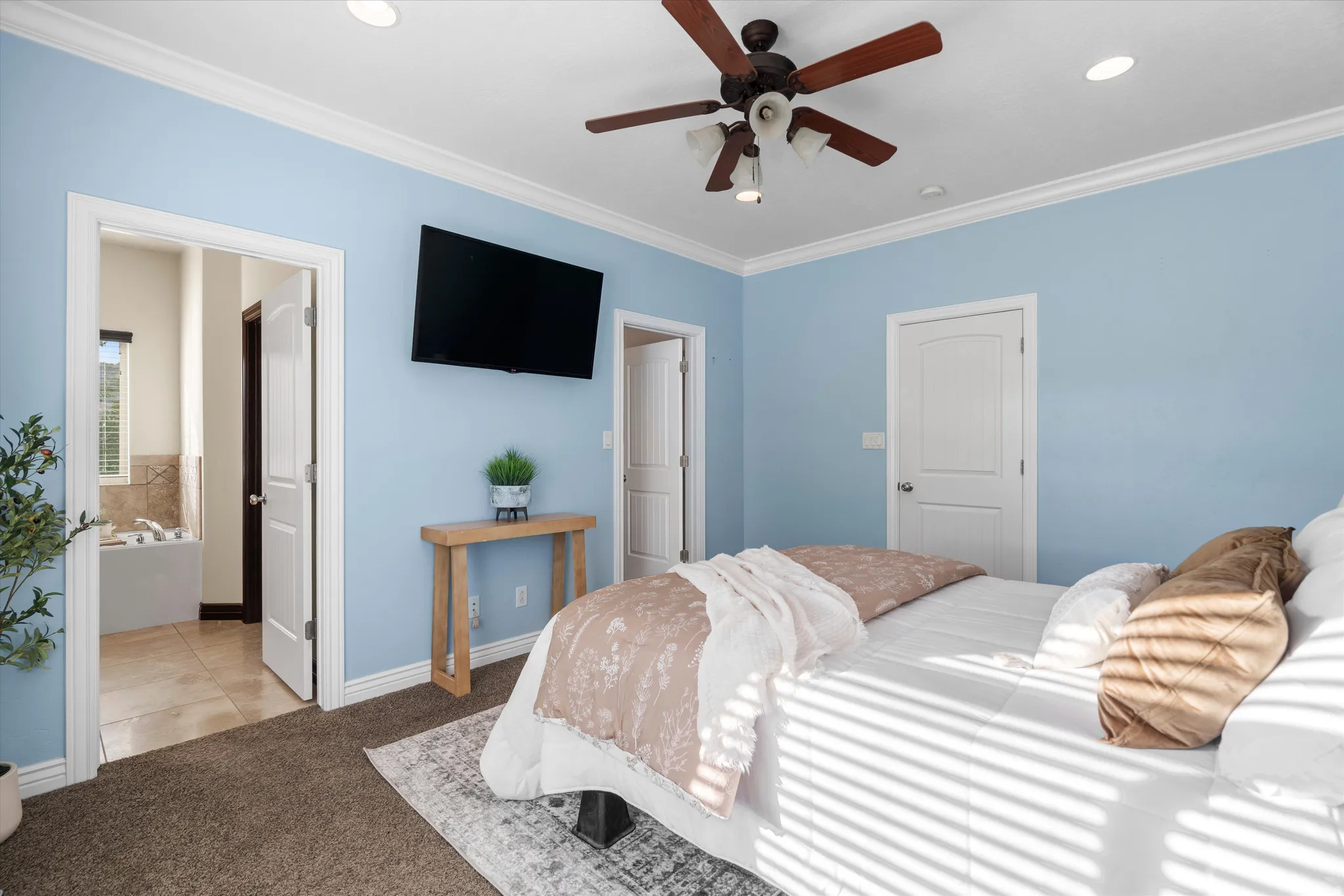 Carpeted bedroom featuring a ceiling fan with integrated lighting, recessed lighting, and crown molding