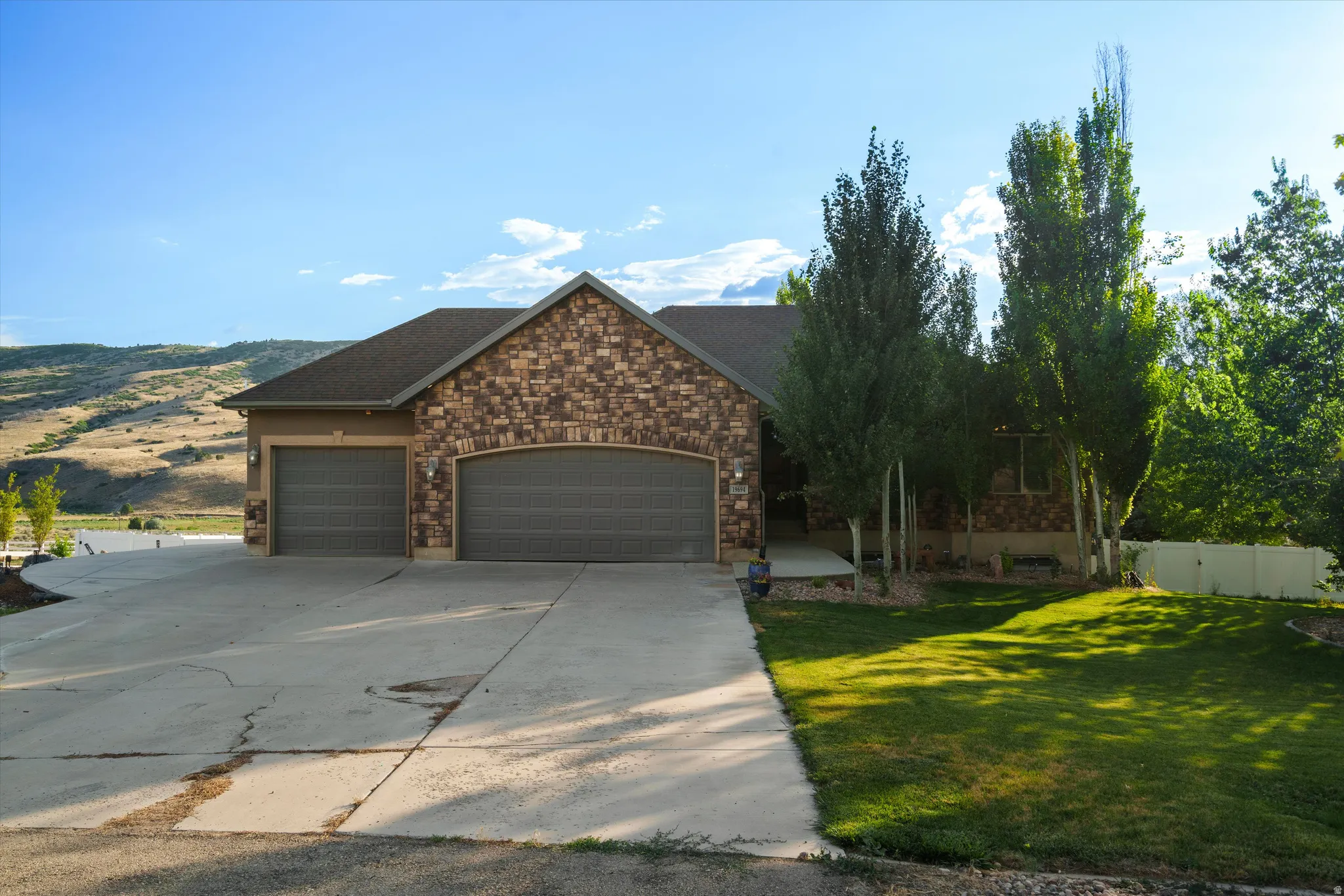Stone and stucco exterior with a two-car garage