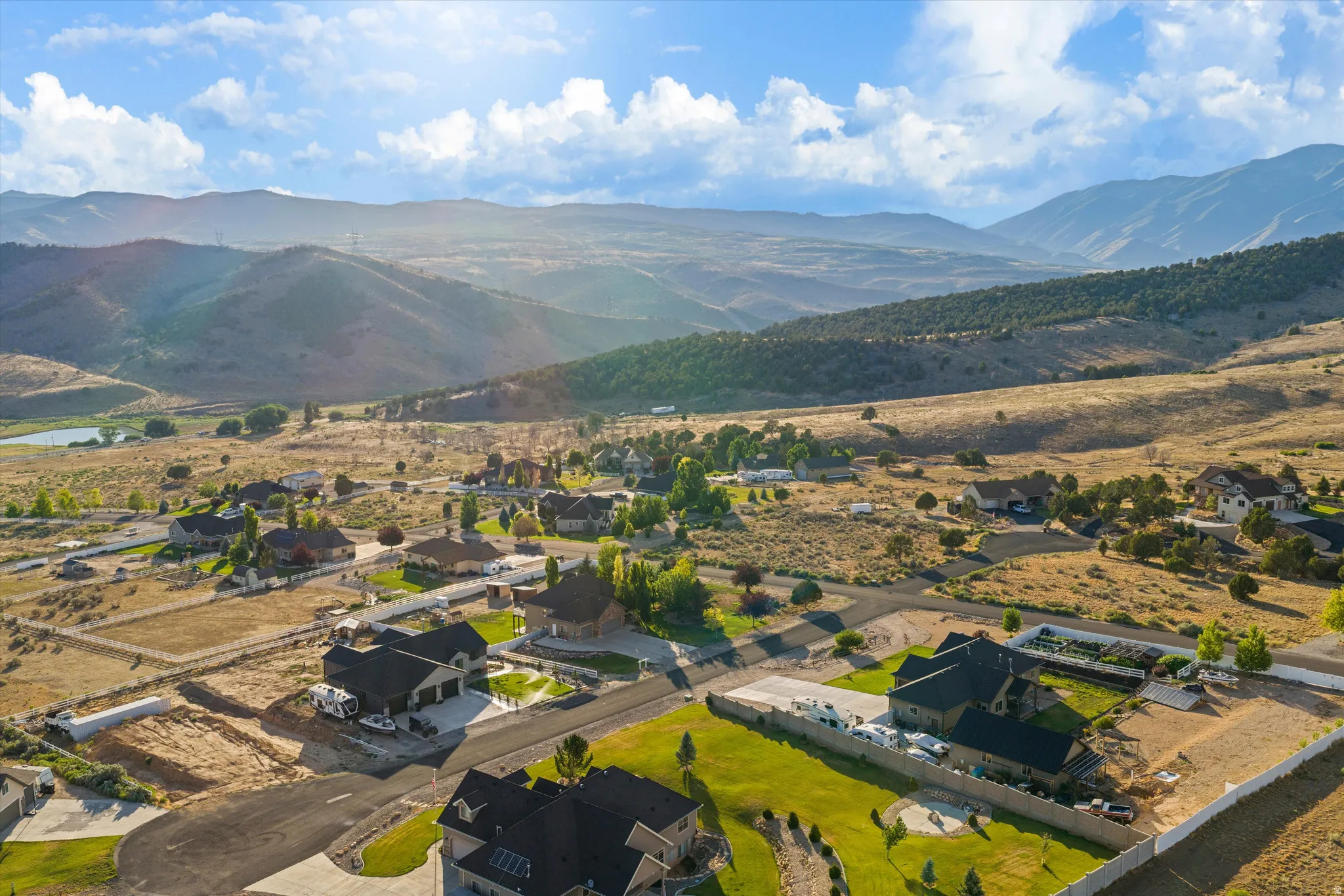 Expansive mountain landscape frames a residential community with paved streets