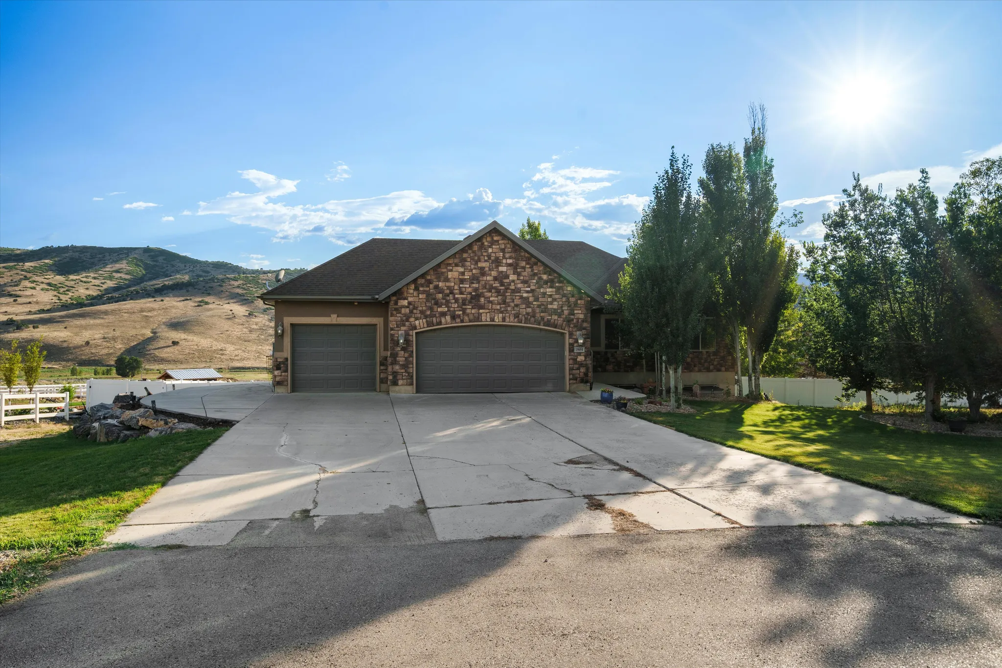 Stone and stucco exterior featuring a two-car garage with individual doors