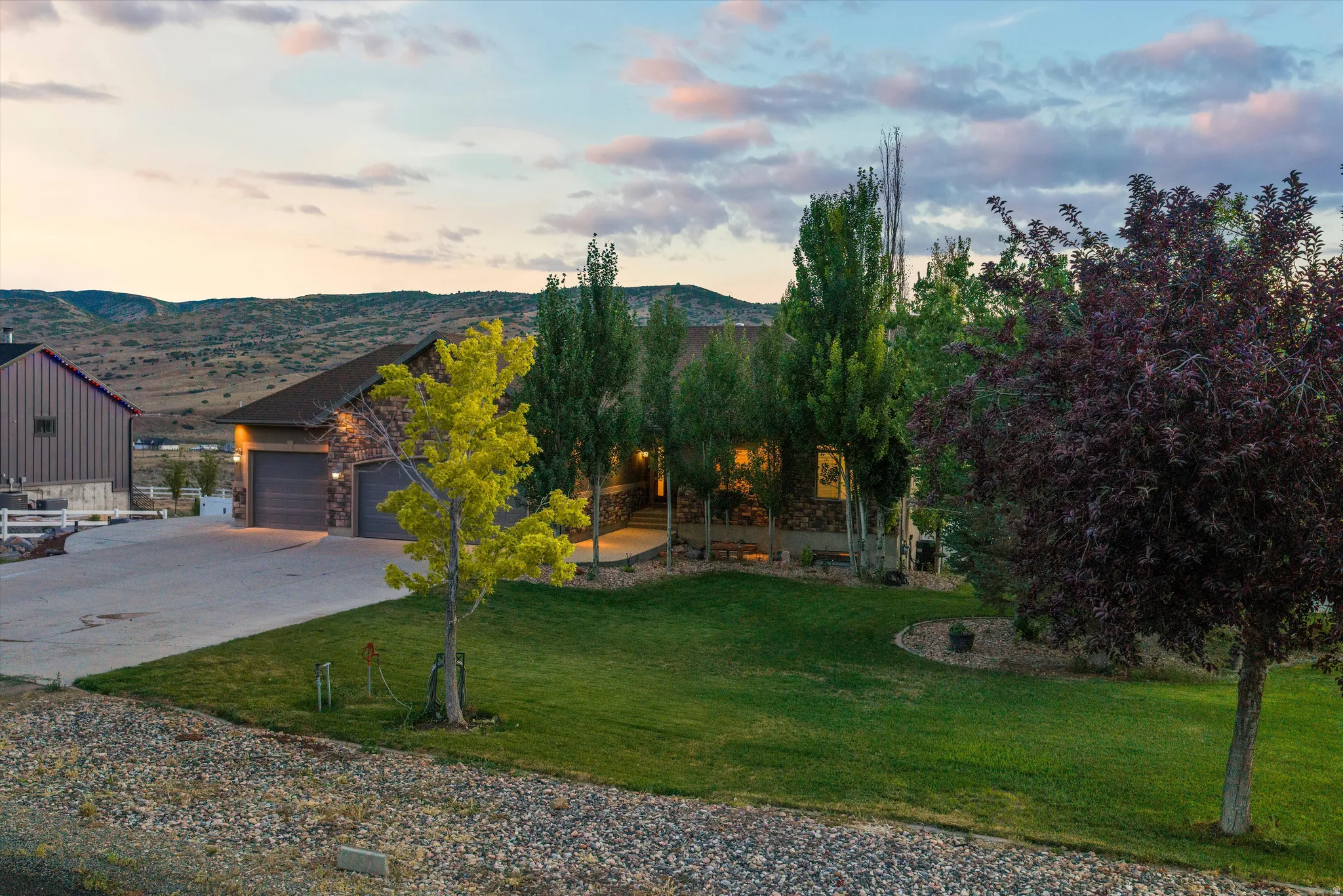 Stone-clad home with a two-car garage and a paved driveway