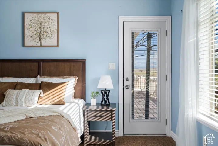 Bedroom featuring a full-light glass panel door providing direct outdoor access