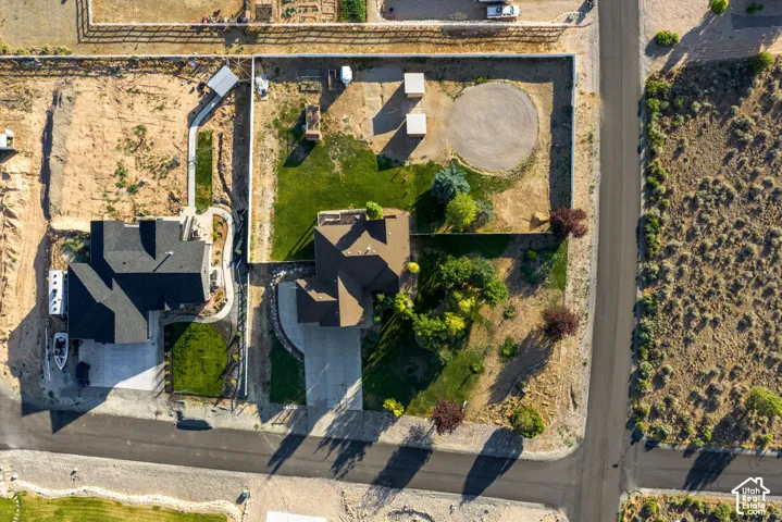 Aerial view showcasing two residential properties with distinct landscaping
