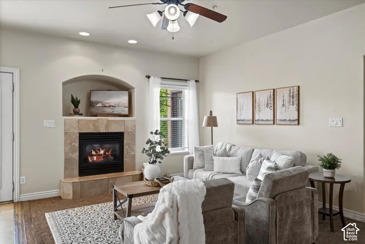 Living area featuring a tile-surround fireplace with an arched alcove
