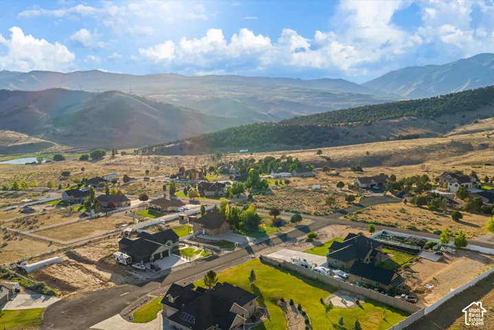 Expansive mountain landscape frames a residential community with paved streets