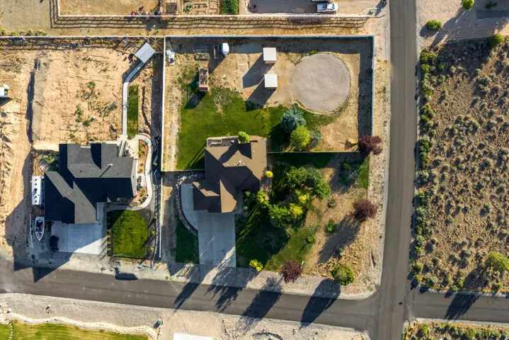 Aerial view showcasing two residential properties with distinct landscaping