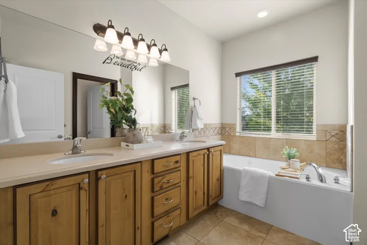 Master Bath with Dual vanity with integrated sinks and a light-toned countertop