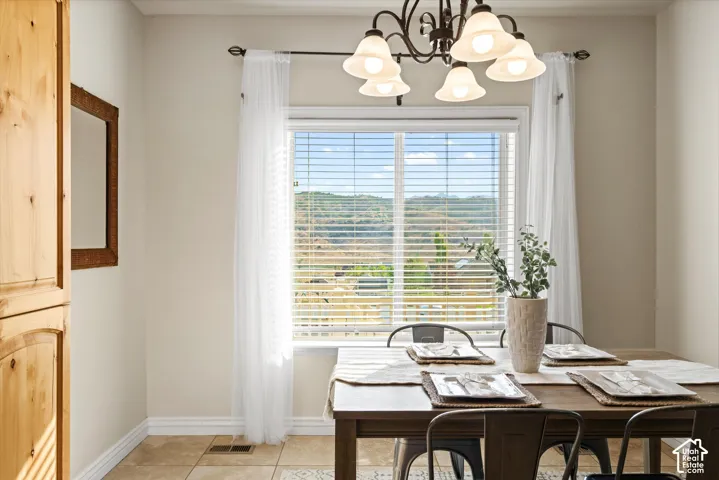 Dining area with a large window, providing natural light and showcasing a distant landscape