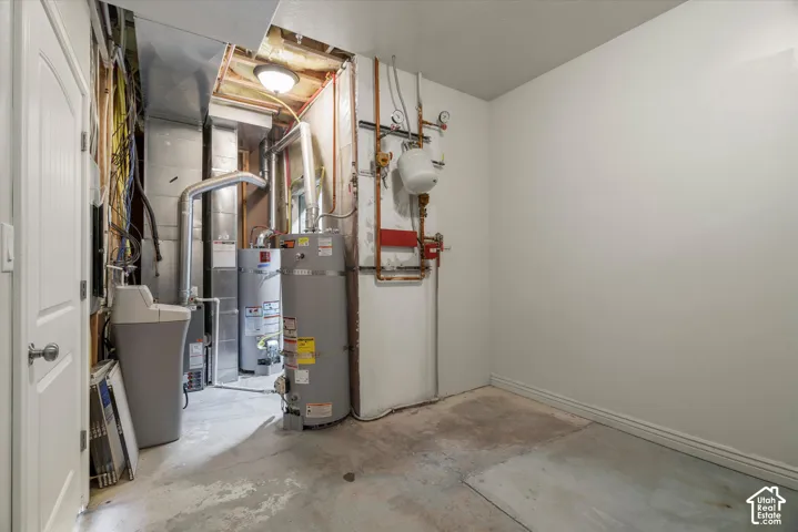 Utility area featuring a water heater, furnace, and water softener system