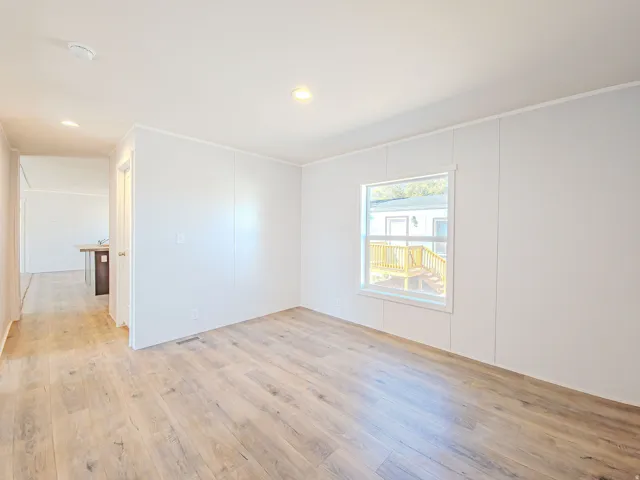 Recessed lighting, wood-finish flooring, and white paneled walls