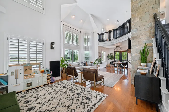 Expansive living area with vaulted ceilings and abundant natural light