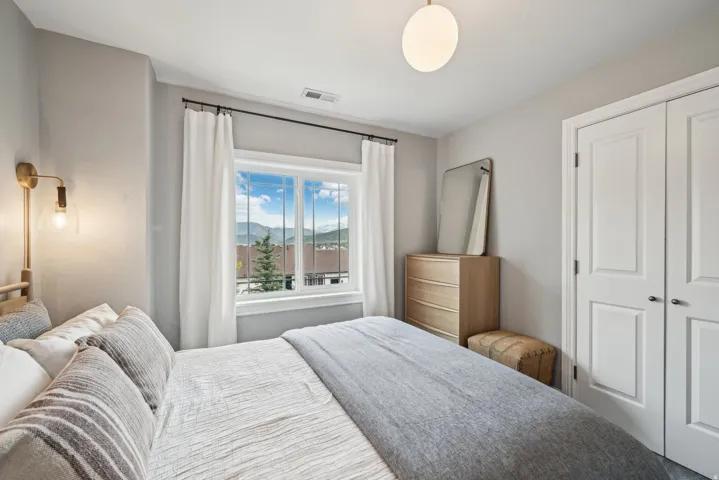 Bright bedroom with a window offering mountain scenery
