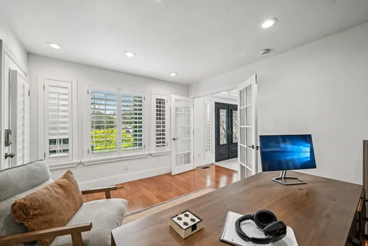 Room featuring wood-finish flooring, recessed lighting, and white walls