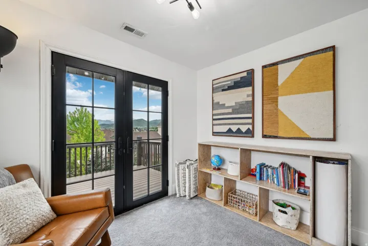 Double French doors opening to an exterior deck with mountain and neighborhood views