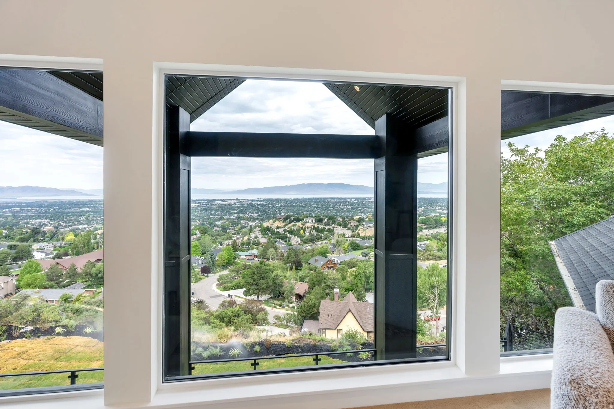 Expansive windows showcasing a panoramic cityscape and distant body of water