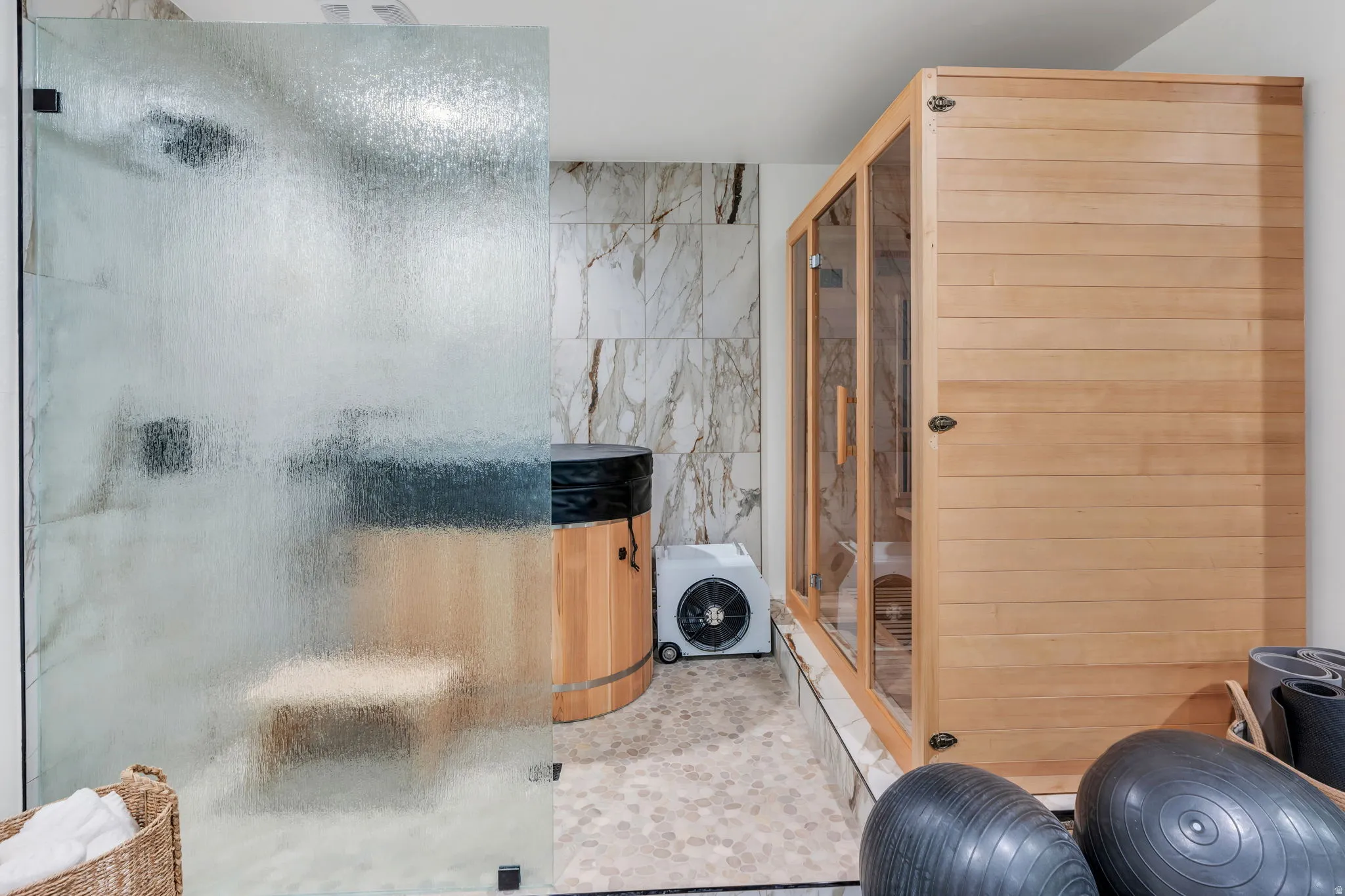 Walk-in shower with frosted glass enclosure, featuring a built-in bench