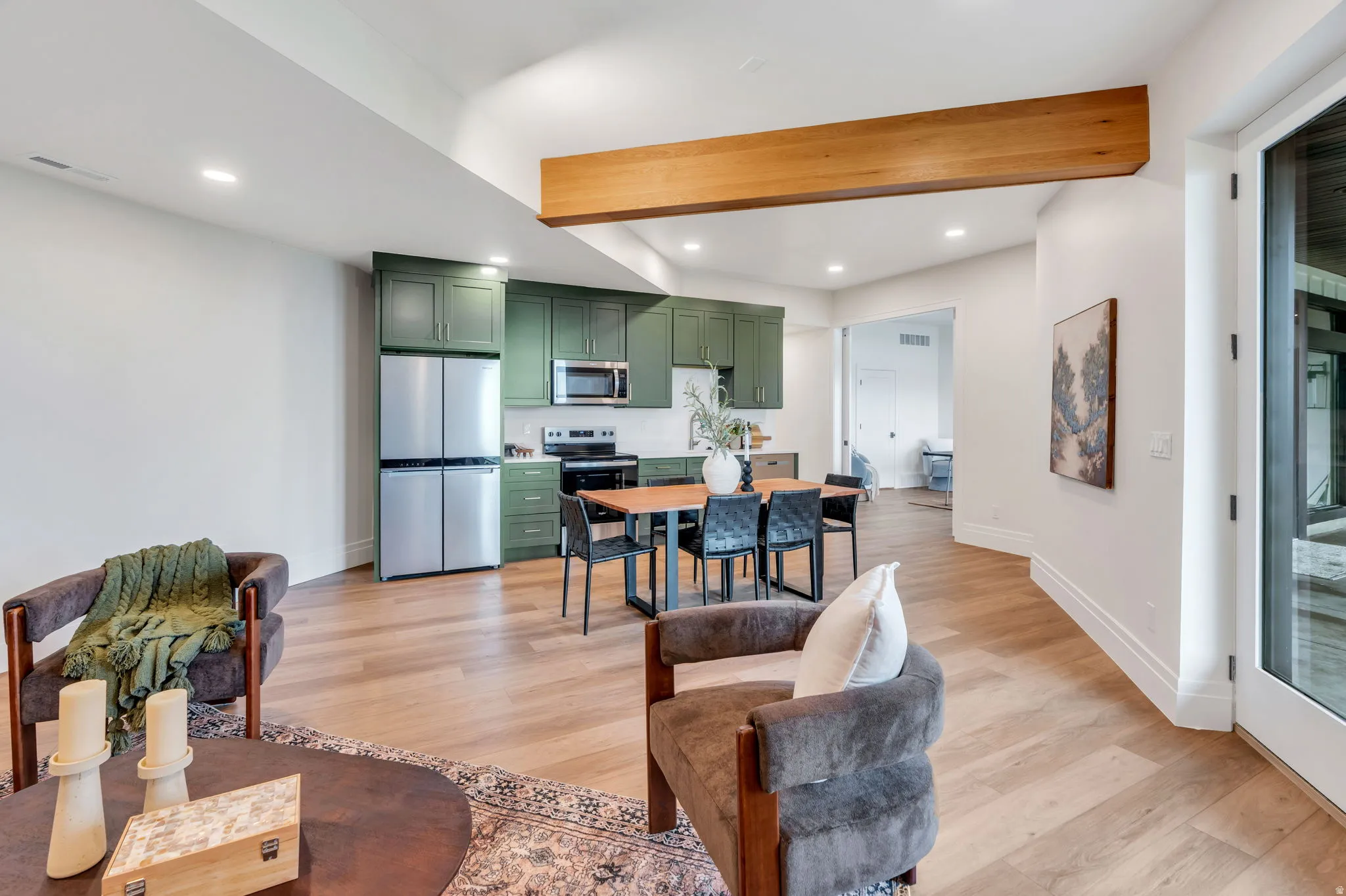 Open concept space featuring wood-finish flooring and recessed lighting