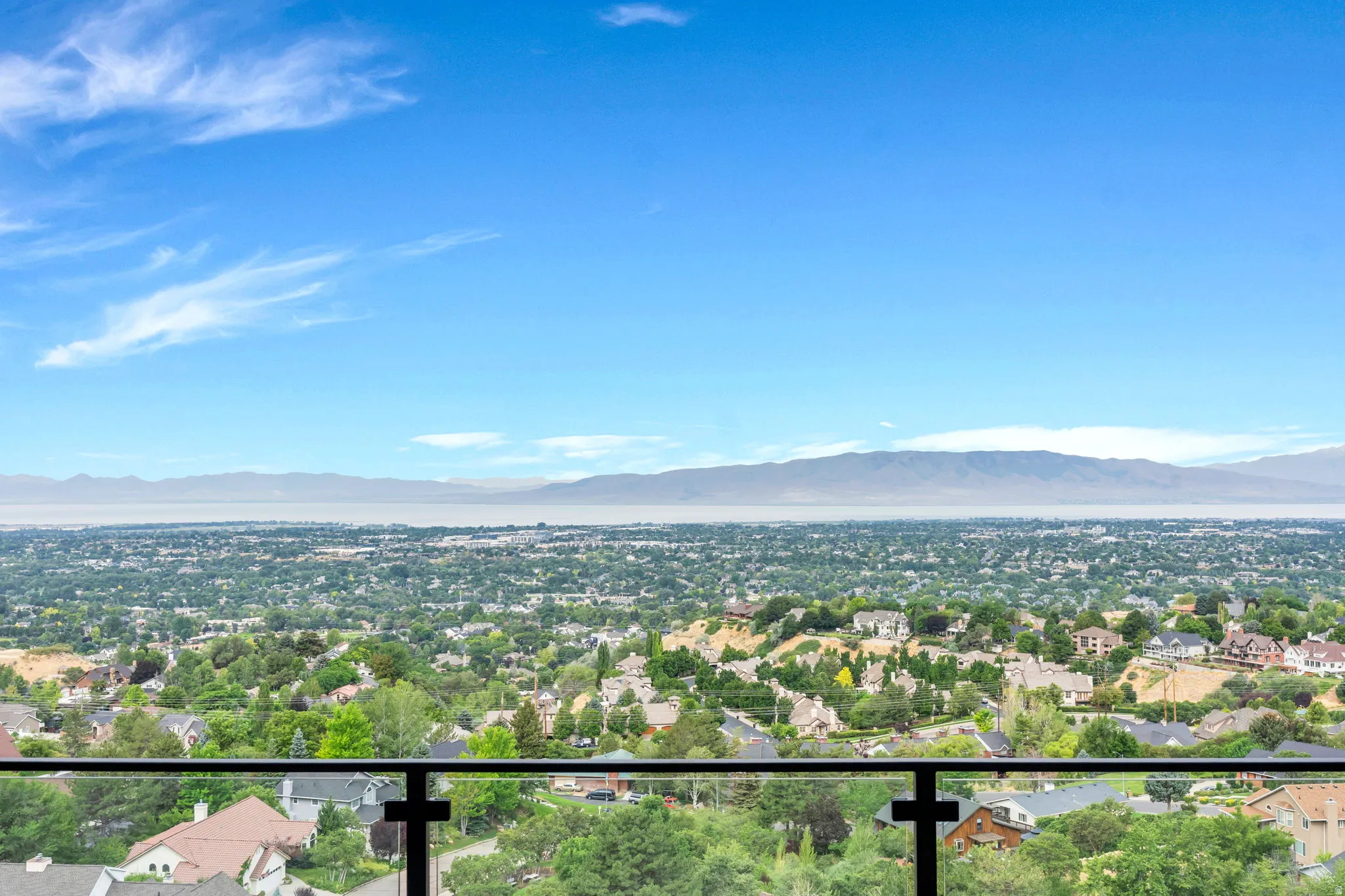 Expansive cityscape with distant mountains and a body of water
