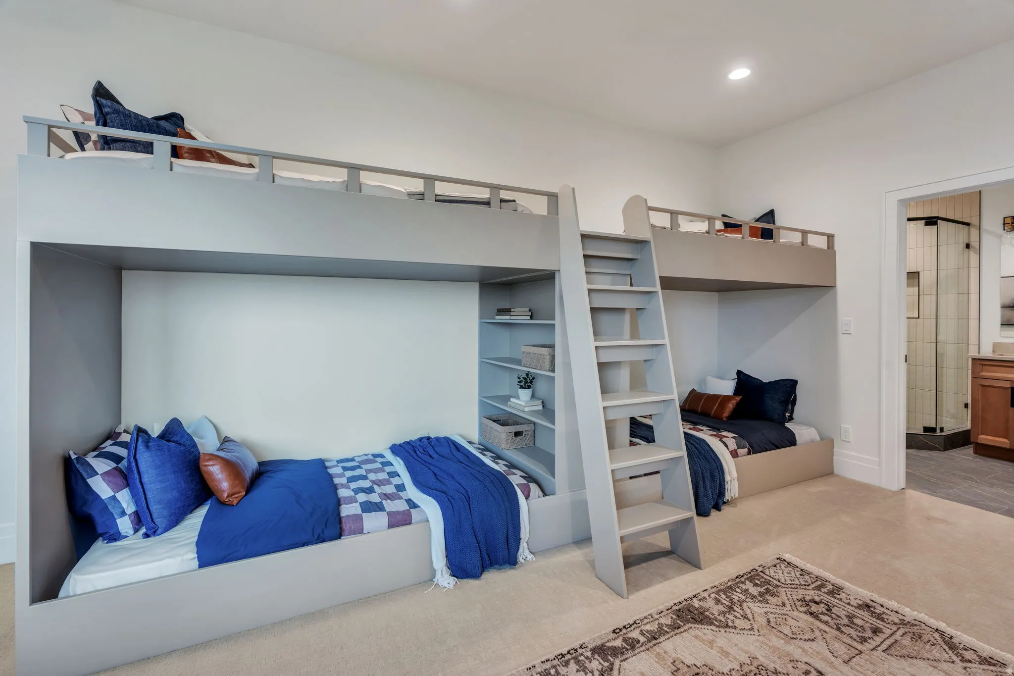 Built-in bunk beds with integrated shelving and ladders