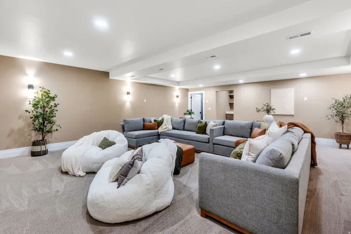 Spacious interior featuring neutral carpeting and recessed lighting