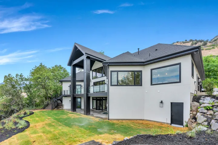 Contemporary exterior featuring white stucco and dark trim