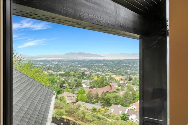 Expansive urban landscape with distant mountains under a blue sky