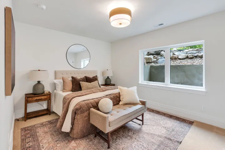 Bedroom featuring light-toned walls, a rectangular window, recessed lighting, and a drum-style ceiling fixture