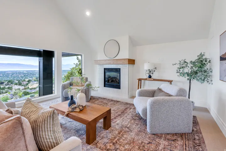 Vaulted ceilings complement the large windows showcasing mountain and city surroundings