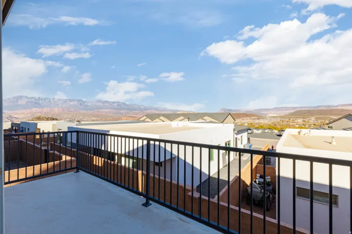 Private balcony featuring black metal railings and a concrete surface