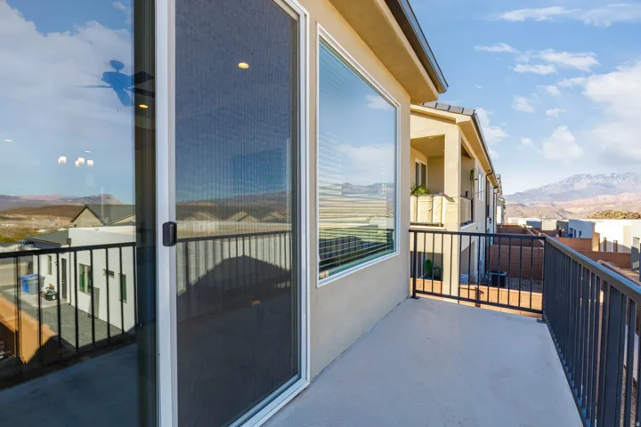 Private balcony featuring a concrete surface and black metal railings