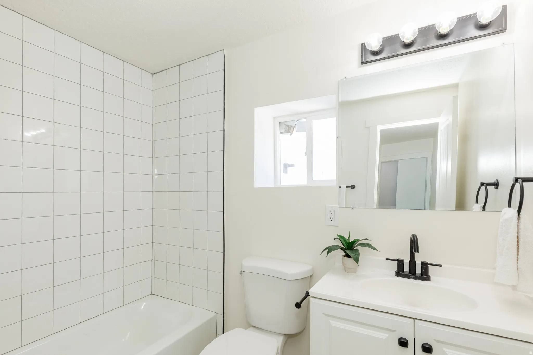 White subway tile shower surround with a built-in tub