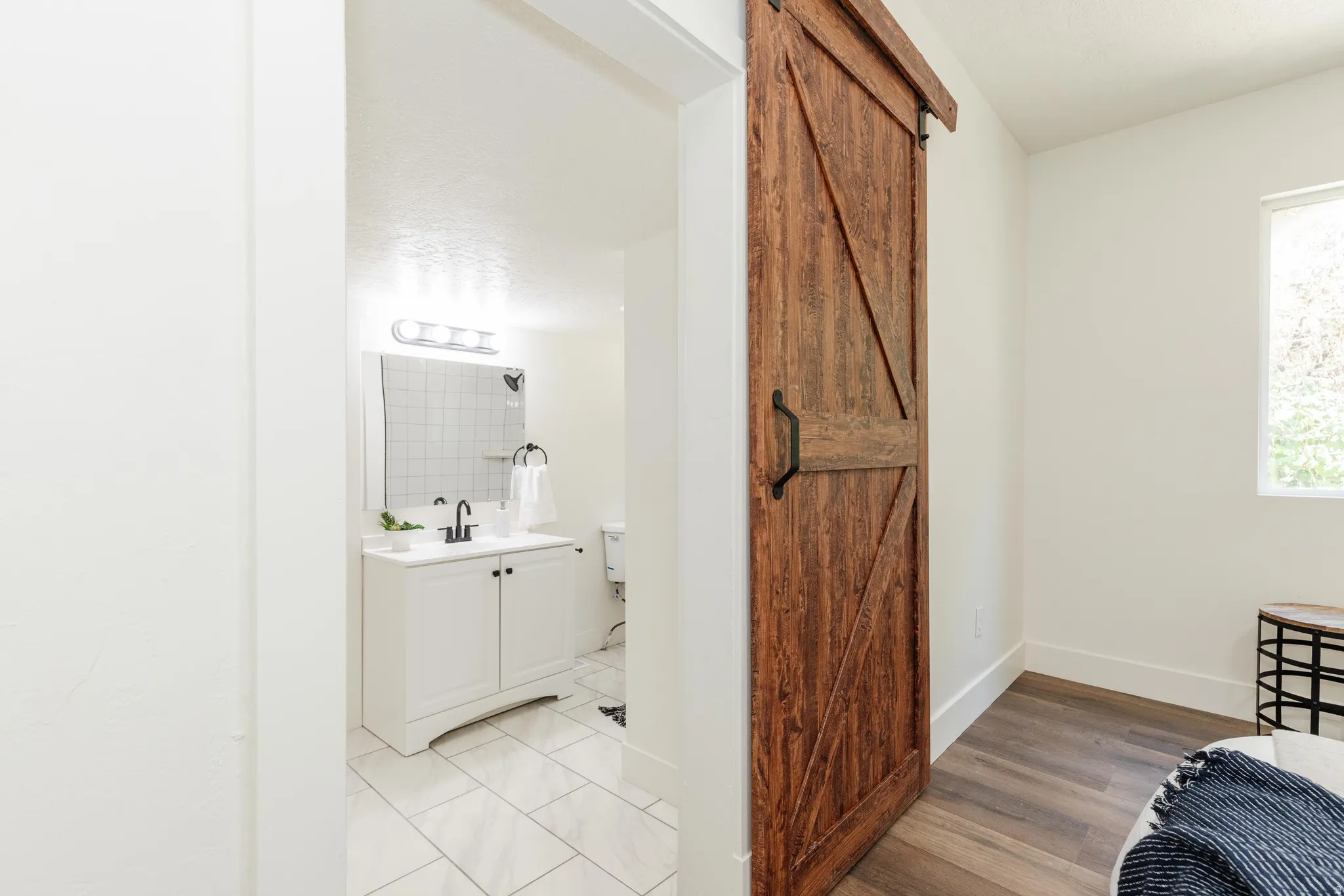 Rustic wood barn door entry with black hardware