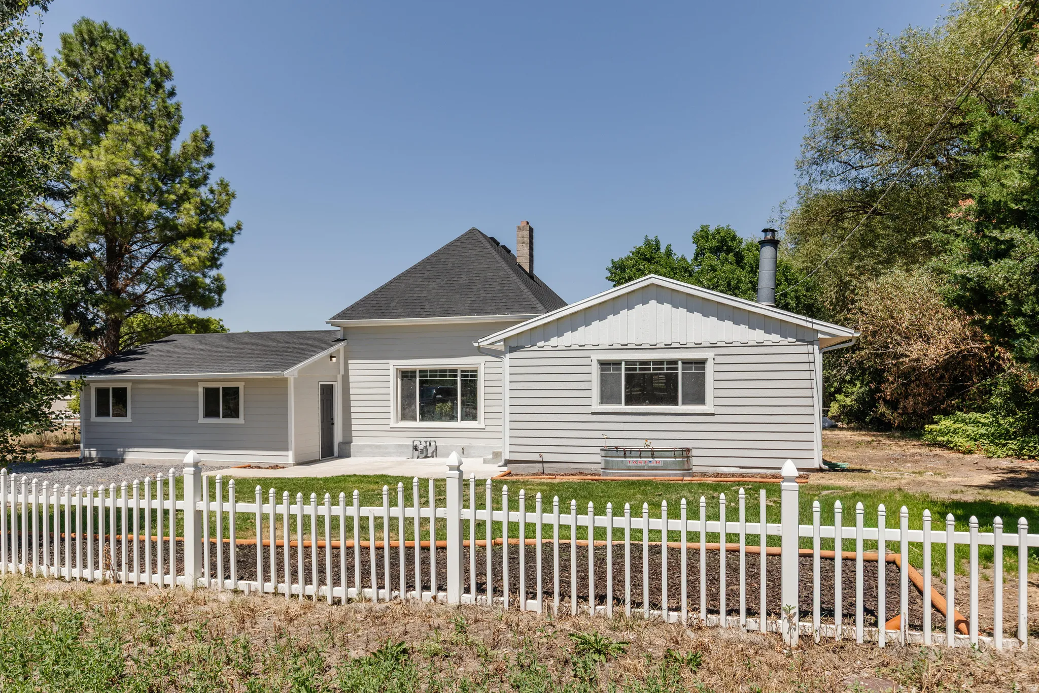 Light gray horizontal siding exterior with a dark shingle roof